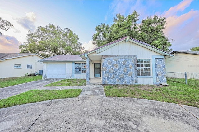 7033 Wentworth Way, New Port Richey, FL 34655 - ranch-style home featuring stone siding, concrete driveway, and an attached garage