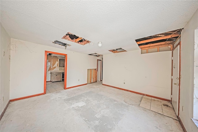 7033 Wentworth Way, New Port Richey, FL 34655 - unfurnished room with baseboards and a textured ceiling