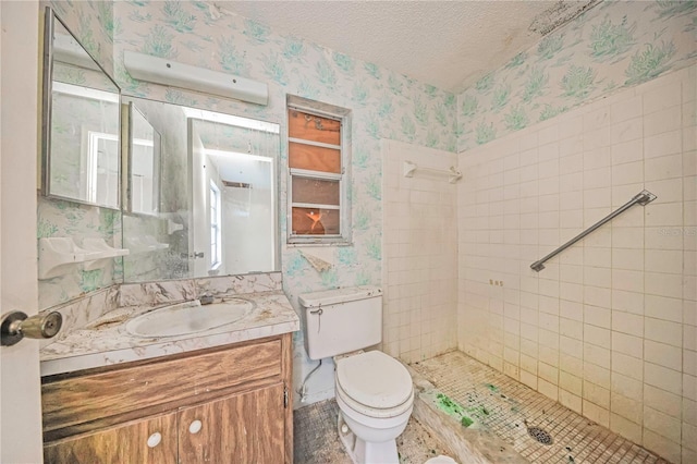 7033 Wentworth Way, New Port Richey, FL 34655 - full bath with wallpapered walls, vanity, toilet, a tile shower, and a textured ceiling