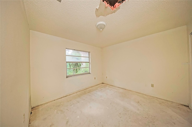 7033 Wentworth Way, New Port Richey, FL 34655 - empty room featuring a textured ceiling and unfinished concrete flooring