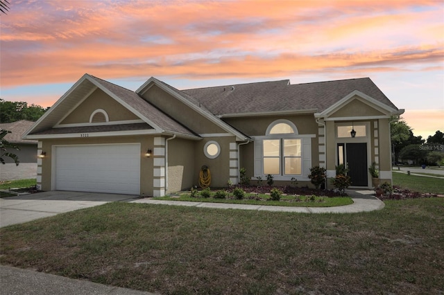 9322 Via Segovia, New Port Richey, FL 34655 - view of front of house featuring stucco siding, driveway, a garage, and a yard