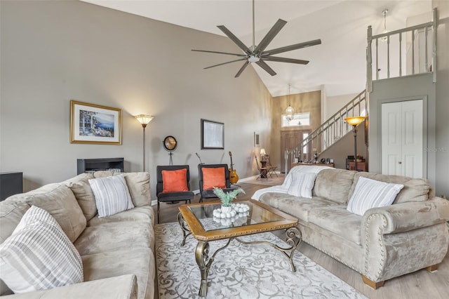 9322 Via Segovia, New Port Richey, FL 34655 - living room with high vaulted ceiling, stairway, wood finished floors, ceiling fan, and baseboards
