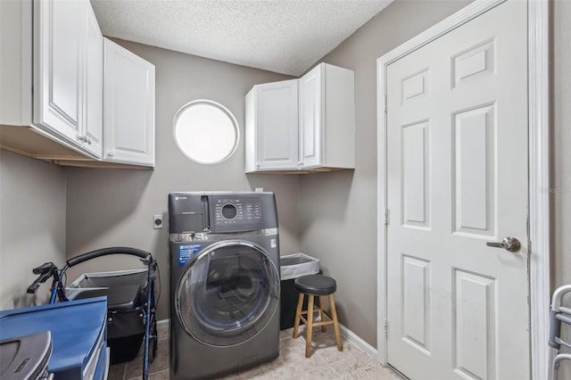 9322 Via Segovia, New Port Richey, FL 34655 - laundry room with washer / dryer, cabinet space, a textured ceiling, baseboards, and light tile patterned floors