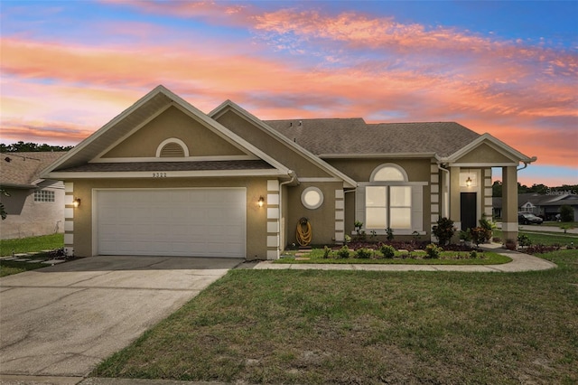9322 Via Segovia, New Port Richey, FL 34655 - view of front of home featuring stucco siding, a front lawn, concrete driveway, and a garage