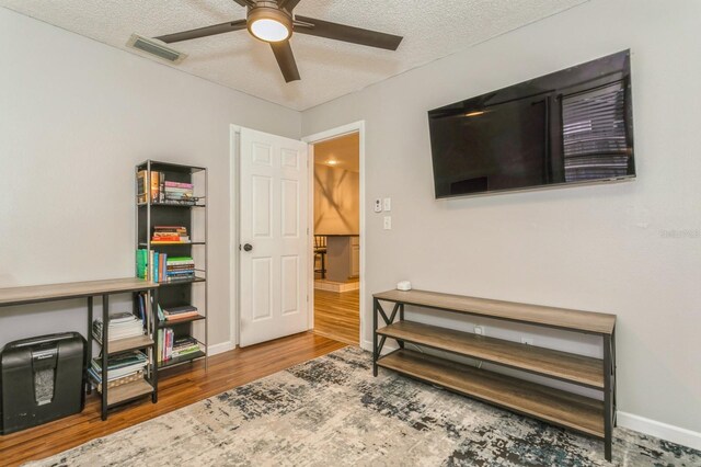 4021 Vana Dr, Sarasota, FL 34241 - living area featuring a ceiling fan, wood finished floors, a textured ceiling, and baseboards