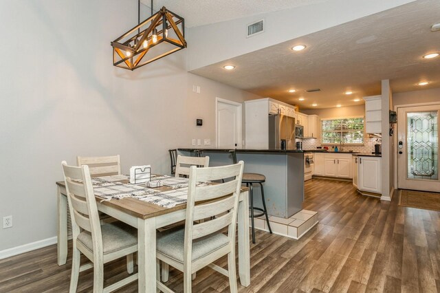 4021 Vana Dr, Sarasota, FL 34241 - dining area featuring dark wood-style floors, recessed lighting, a chandelier, and baseboards