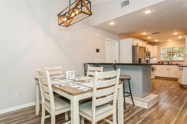 4021 Vana Dr, Sarasota, FL 34241 - dining area with dark wood-type flooring, recessed lighting, a chandelier, and baseboards