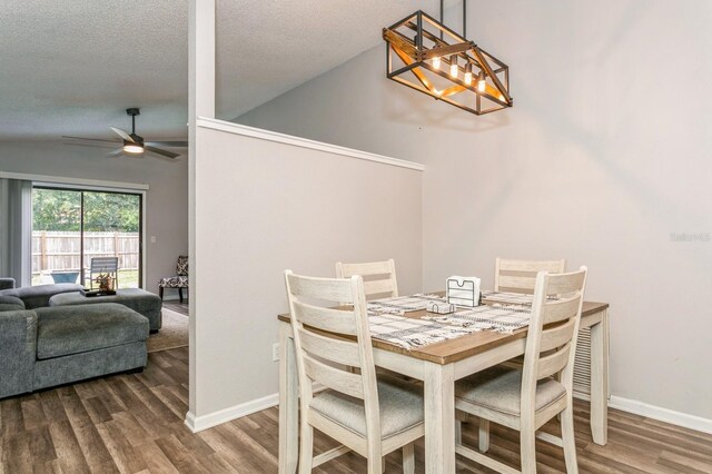4021 Vana Dr, Sarasota, FL 34241 - dining space featuring a ceiling fan, vaulted ceiling, wood finished floors, a textured ceiling, and baseboards
