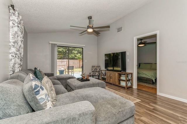 4021 Vana Dr, Sarasota, FL 34241 - living room with ceiling fan, vaulted ceiling, wood finished floors, a textured ceiling, and baseboards