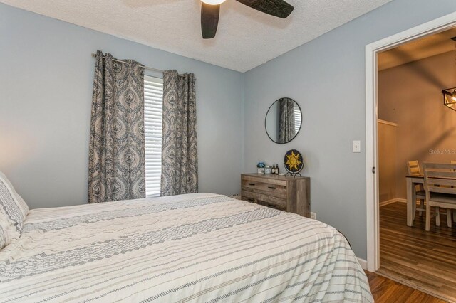 4021 Vana Dr, Sarasota, FL 34241 - bedroom featuring wood finished floors, a textured ceiling, a ceiling fan, and baseboards