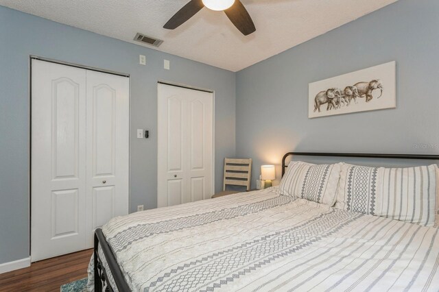 4021 Vana Dr, Sarasota, FL 34241 - bedroom featuring wood finished floors, two closets, ceiling fan, and baseboards