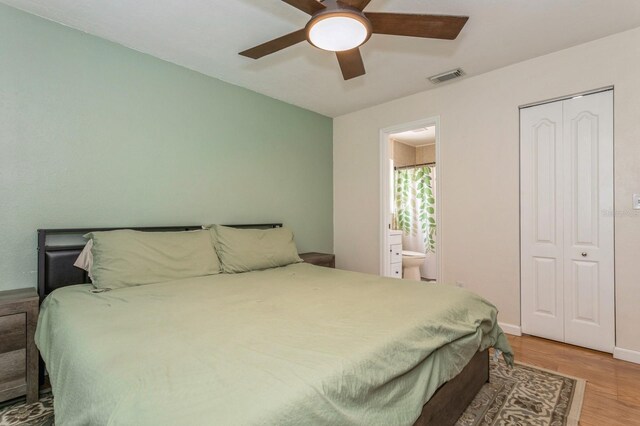4021 Vana Dr, Sarasota, FL 34241 - bedroom featuring wood finished floors, baseboards, connected bathroom, a closet, and a ceiling fan
