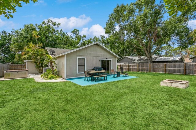 4021 Vana Dr, Sarasota, FL 34241 - rear view of property featuring a hot tub, a patio, a fire pit, and central air condition unit