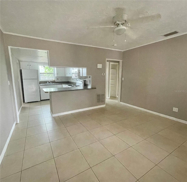 72 Lake Shore Dr, Palm Harbor, FL 34684 - kitchen featuring white appliances, a peninsula, a ceiling fan, light tile patterned flooring, and ornamental molding