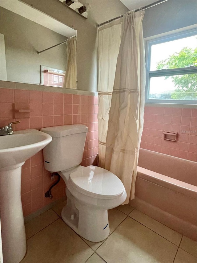 72 Lake Shore Dr, Palm Harbor, FL 34684 - full bath with tile walls, tile patterned floors, shower / bathtub combination with curtain, and wainscoting