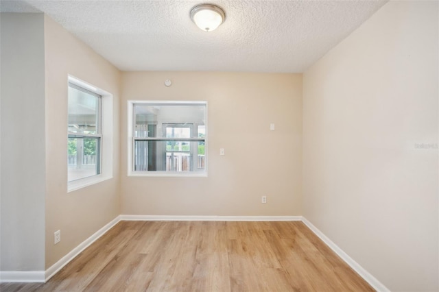 15202 Morning Dr, Lutz, FL 33559 - unfurnished room featuring light wood finished floors, a textured ceiling, and baseboards