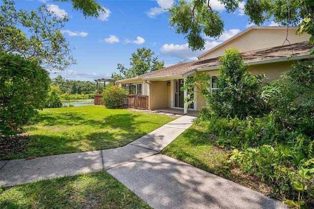 15202 Morning Dr, Lutz, FL 33559 - view of front of home with a front lawn and a water view