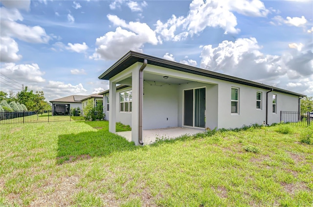 6119 Bradford Woods Dr, Zephyrhills, FL 33542 - rear view of house with stucco siding and a patio