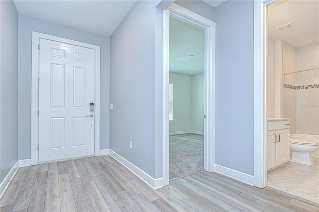 6119 Bradford Woods Dr, Zephyrhills, FL 33542 - entryway with light wood-type flooring and baseboards