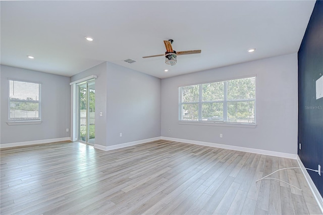 6119 Bradford Woods Dr, Zephyrhills, FL 33542 - spare room featuring plenty of natural light, a ceiling fan, light wood finished floors, and recessed lighting