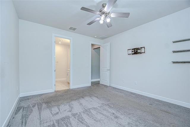 6119 Bradford Woods Dr, Zephyrhills, FL 33542 - unfurnished bedroom featuring carpet, ensuite bathroom, baseboards, and ceiling fan