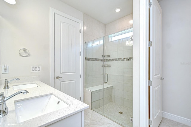6119 Bradford Woods Dr, Zephyrhills, FL 33542 - bathroom with a stall shower, double vanity, and baseboards