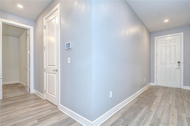 6119 Bradford Woods Dr, Zephyrhills, FL 33542 - corridor with light wood-type flooring, baseboards, and recessed lighting