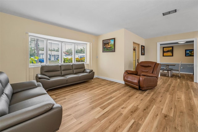 1412 Coburn Dr, Tarpon Springs, FL 34689 - living area with light wood-type flooring and baseboards