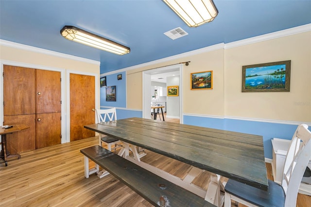 1412 Coburn Dr, Tarpon Springs, FL 34689 - dining space featuring wood finished floors and ornamental molding