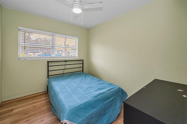 1412 Coburn Dr, Tarpon Springs, FL 34689 - bedroom with wood finished floors, baseboards, and ceiling fan