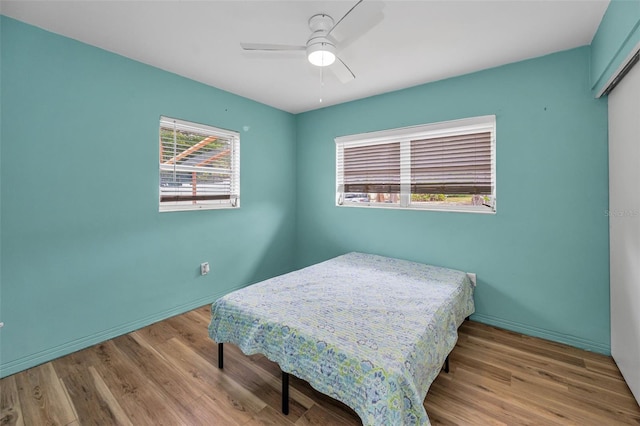 1412 Coburn Dr, Tarpon Springs, FL 34689 - bedroom featuring wood finished floors, baseboards, a closet, and ceiling fan