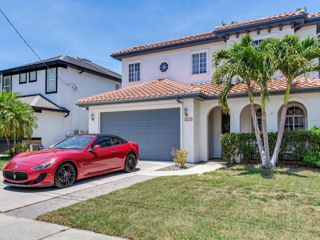 3003 W Leila Ave, Tampa, FL 33611 - mediterranean / spanish home with a tile roof, stucco siding, a front lawn, an attached garage, and concrete driveway