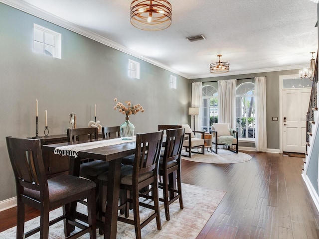 3003 W Leila Ave, Tampa, FL 33611 - dining room with a chandelier, crown molding, hardwood / wood-style floors, and baseboards