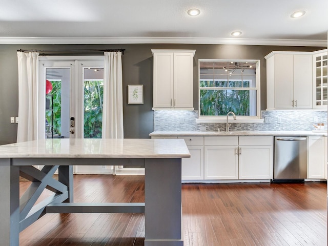 3003 W Leila Ave, Tampa, FL 33611 - kitchen with a sink, dishwasher, healthy amount of natural light, white cabinetry, and crown molding