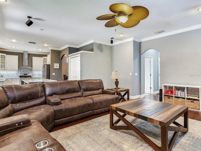 3003 W Leila Ave, Tampa, FL 33611 - living area featuring arched walkways, wood finished floors, a ceiling fan, ornamental molding, and baseboards