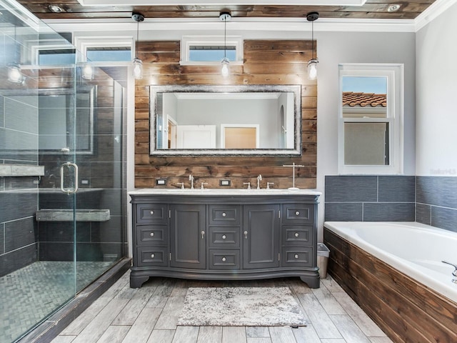 3003 W Leila Ave, Tampa, FL 33611 - bathroom featuring double vanity, a garden tub, ornamental molding, a stall shower, and wood finished floors