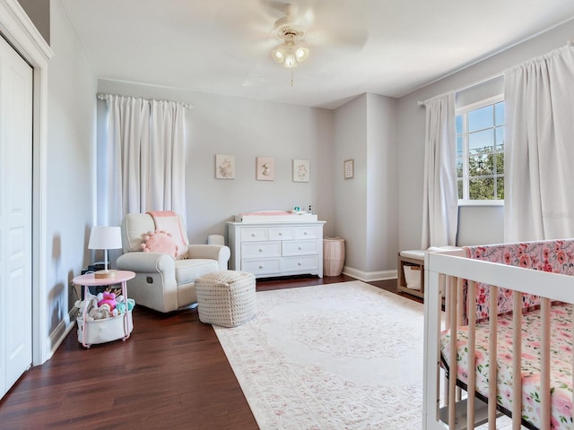 3003 W Leila Ave, Tampa, FL 33611 - bedroom with dark wood finished floors, a nursery area, ceiling fan, and baseboards