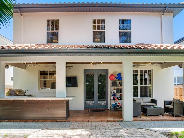 3003 W Leila Ave, Tampa, FL 33611 - rear view of house featuring french doors, outdoor lounge area, stucco siding, and a patio