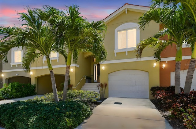 17 Franklin Ct S Unit C, Saint Petersburg, FL 33711 - view of front facade featuring an attached garage, driveway, and stucco siding