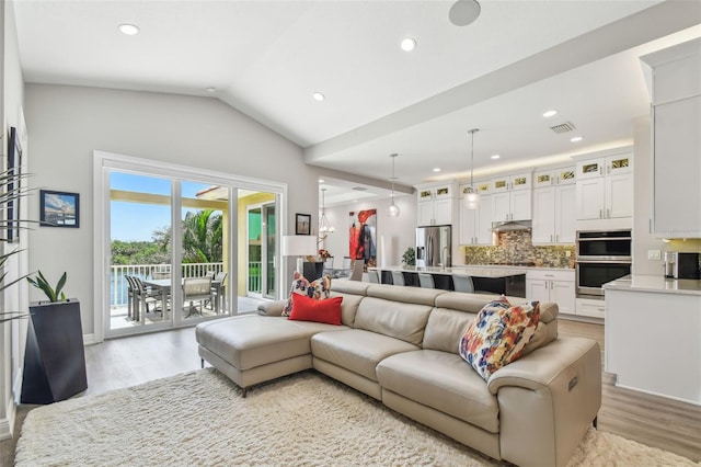 17 Franklin Ct S Unit C, Saint Petersburg, FL 33711 - living room featuring light wood-type flooring, vaulted ceiling, and recessed lighting