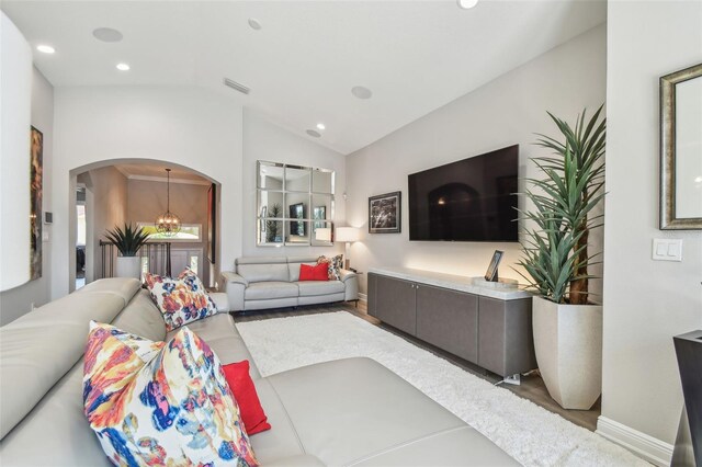 17 Franklin Ct S Unit C, Saint Petersburg, FL 33711 - living area with vaulted ceiling, wood finished floors, arched walkways, recessed lighting, and a chandelier