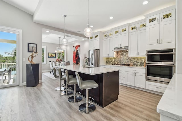 17 Franklin Ct S Unit C, Saint Petersburg, FL 33711 - kitchen with appliances with stainless steel finishes, a sink, recessed lighting, light wood-style floors, and decorative backsplash