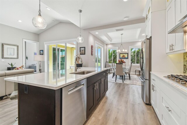 17 Franklin Ct S Unit C, Saint Petersburg, FL 33711 - kitchen featuring appliances with stainless steel finishes, a sink, light wood-type flooring, white cabinets, and recessed lighting