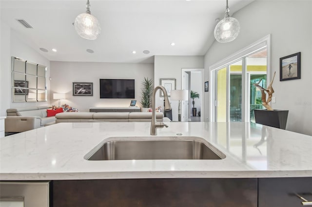 17 Franklin Ct S Unit C, Saint Petersburg, FL 33711 - kitchen featuring a sink, open floor plan, light stone counters, hanging light fixtures, and recessed lighting