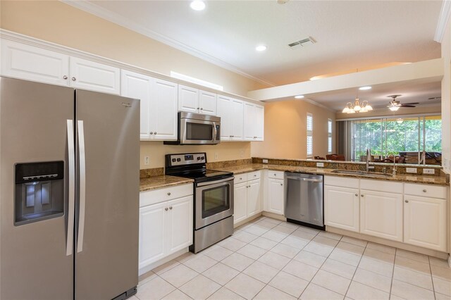 21209 Diamonte Dr, Land O Lakes, FL 34637 - kitchen with stainless steel appliances, a sink, white cabinets, recessed lighting, and ornamental molding