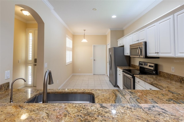 21209 Diamonte Dr, Land O Lakes, FL 34637 - kitchen with appliances with stainless steel finishes, a sink, light stone countertops, ornamental molding, and white cabinetry