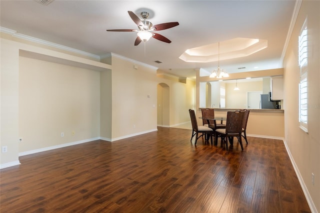 21209 Diamonte Dr, Land O Lakes, FL 34637 - dining space featuring arched walkways, dark wood-style floors, ceiling fan, a raised ceiling, and crown molding
