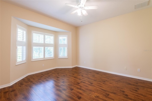 21209 Diamonte Dr, Land O Lakes, FL 34637 - empty room with dark wood-type flooring, baseboards, and a ceiling fan