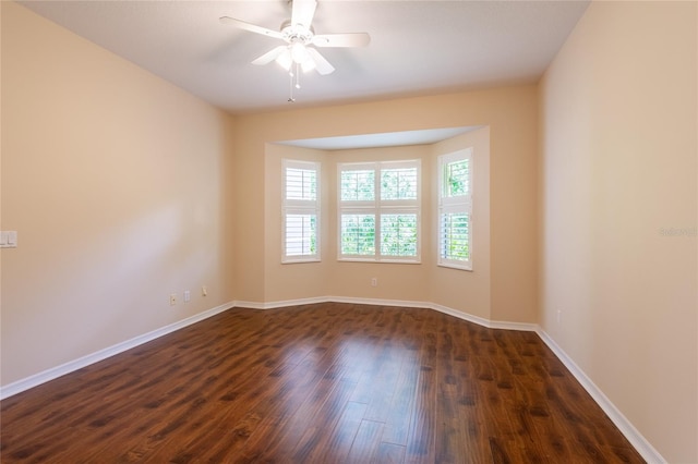 21209 Diamonte Dr, Land O Lakes, FL 34637 - unfurnished room featuring dark wood-style floors, baseboards, and ceiling fan