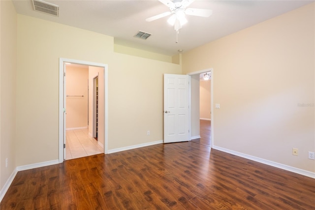 21209 Diamonte Dr, Land O Lakes, FL 34637 - unfurnished bedroom with wood finished floors, baseboards, a ceiling fan, and connected bathroom